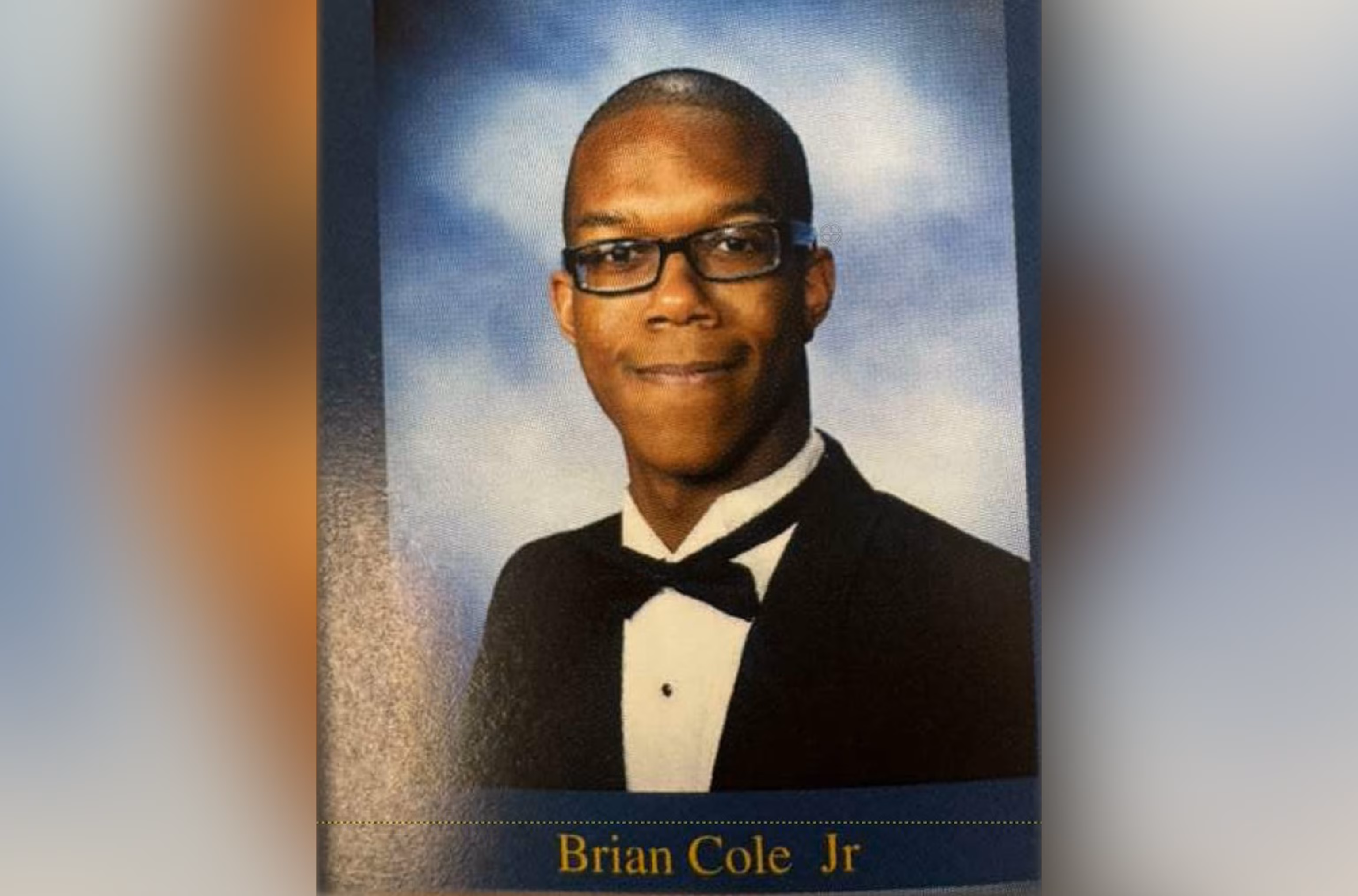 Brian Cole Jr.'s senior yearbook portrait from C.D. Hylton High School, wearing glasses, a black tuxedo jacket and a bow tie against a blue studio backdrop, his name printed in gold beneath the photo