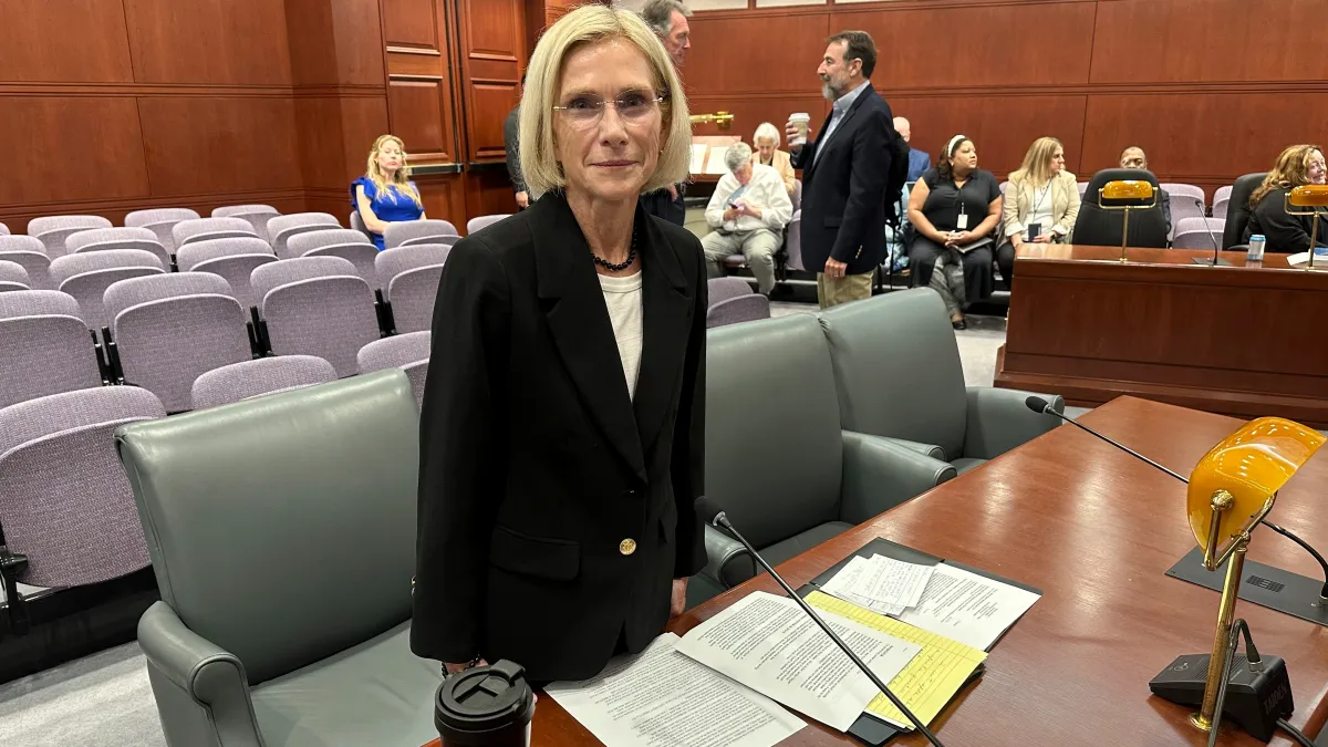 Nora Dannehy standing in a congressional hearing room
