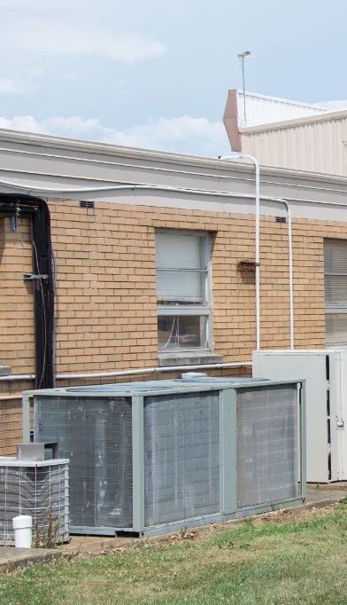 The rooftop air conditioning unit and vertical piping on the side of the AGR International building that investigators say Crooks used to climb onto the roof