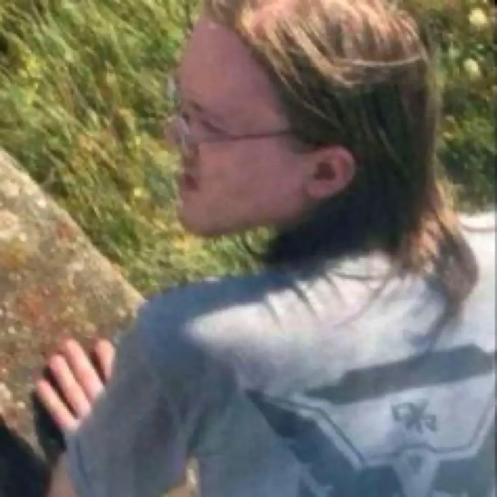 A closer crop of the same photograph, showing Crooks's face in profile on the roof, wearing glasses