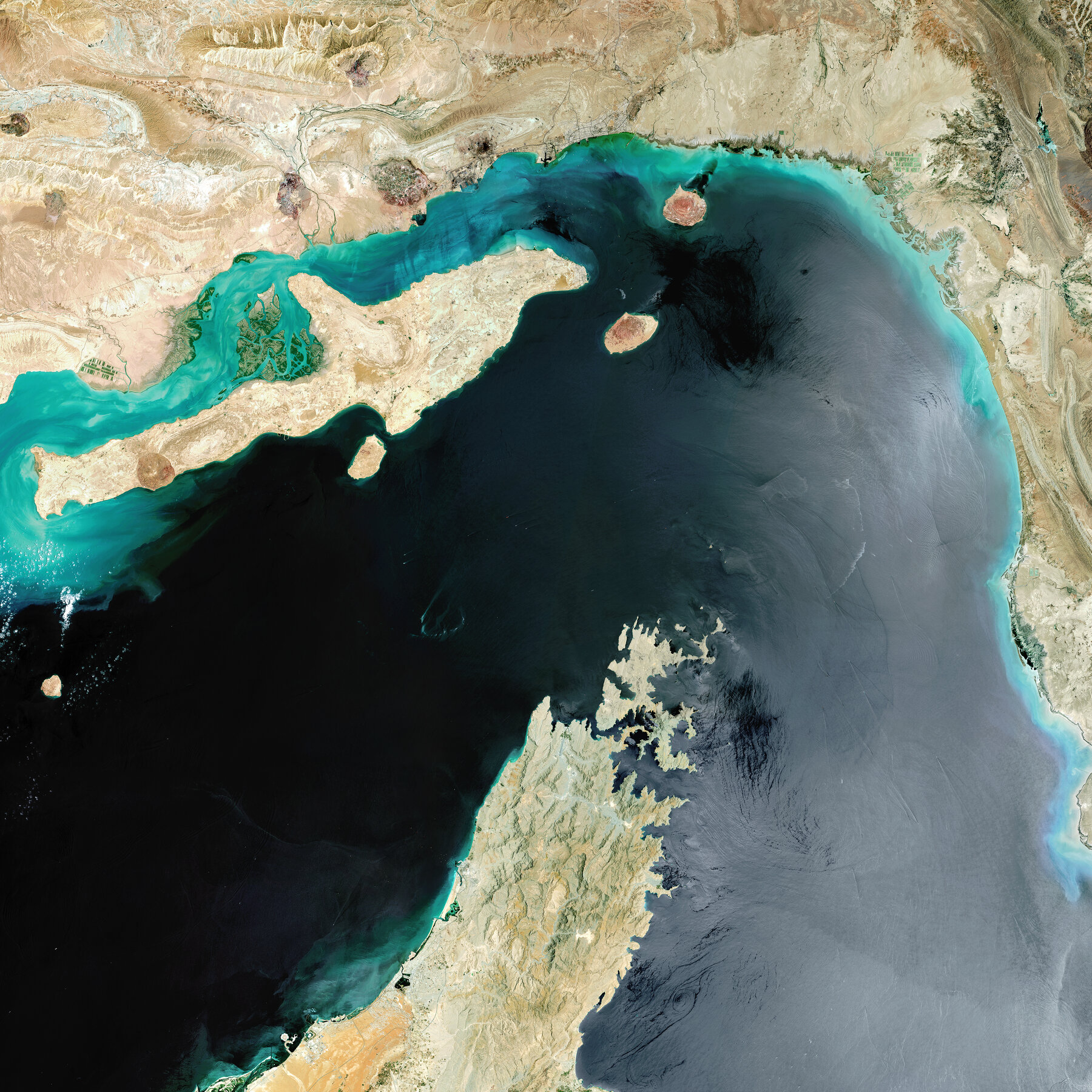 A satellite image of the Iranian coastline along the Strait of Hormuz