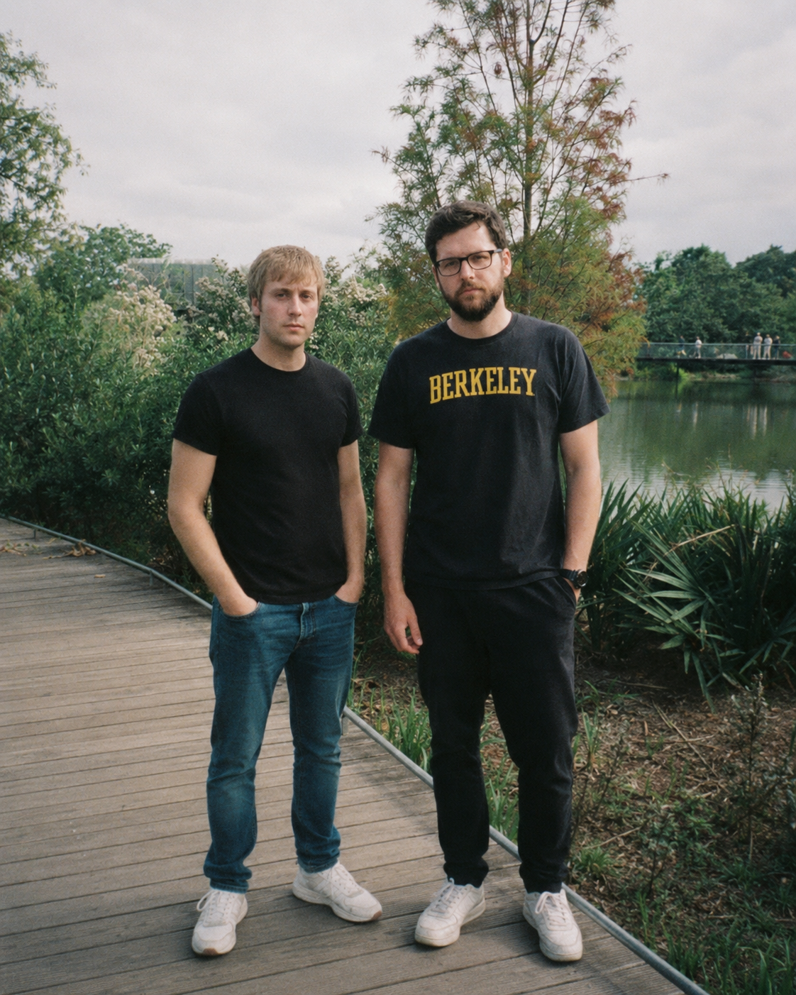 Robbie Bizzle and Michael Mendy standing on a boardwalk by a lake in the East Bay