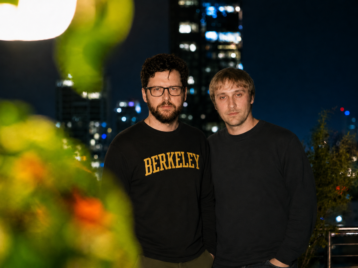 Robbie Bizzle and Michael Mendy standing together on a rooftop at Perch in Los Angeles at night